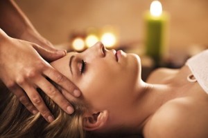 Woman receiving facial massage.